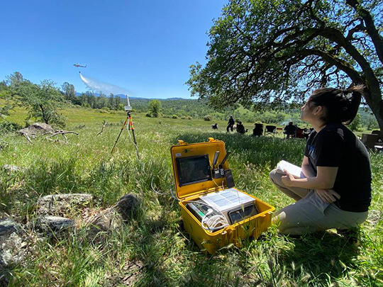 NASA researcher in the field with a UASP-kit during a widefire firefighting operation.