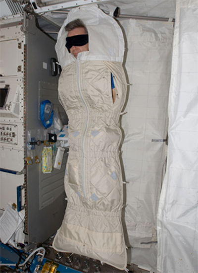 Astronaut sleeping aboard Shuttle