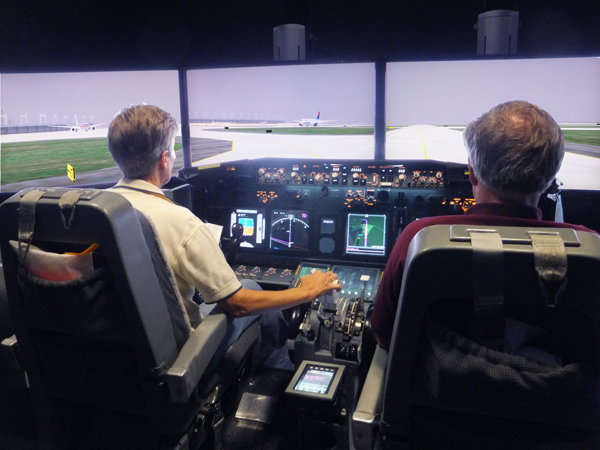 Test pilots are using a flight simulator in the Human-Centered Systems Laboratory