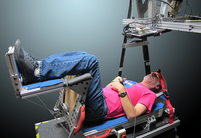 A NASA researcher is strapped into the Human Vibration Laboratory's Vibration Research Chair