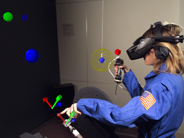 A NASA researcher is demonstrating Virtual Environments Research