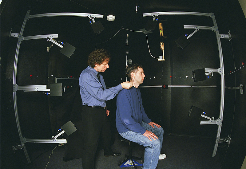 A NASA researcher is working with a research subject during a 3D-Audio Research Laboratory study